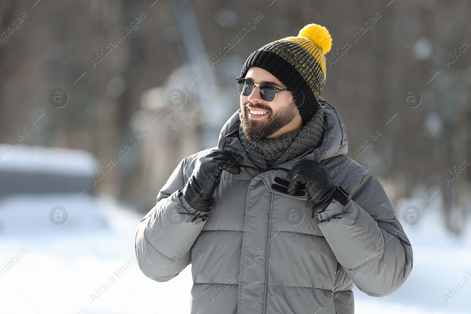 Photo of Portrait of handsome young man with sunglasses on winter day outdoors