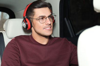 Handsome man listening to audiobook in car