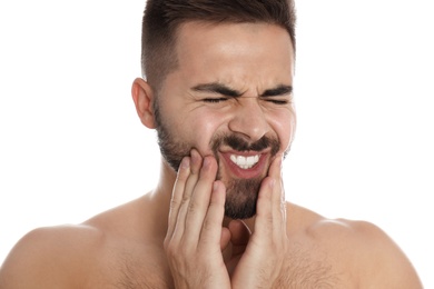 Photo of Man suffering from acute toothache on white background, closeup