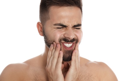 Man suffering from acute toothache on white background, closeup