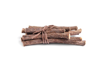 Photo of Dried sticks of liquorice root on white background