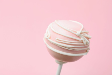 Photo of Sweet decorated cake pop on pink background