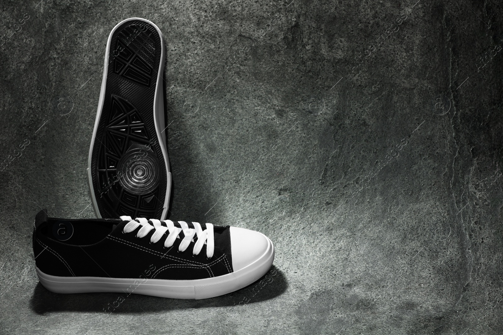 Photo of Pair of stylish sneakers on grey background, space for text