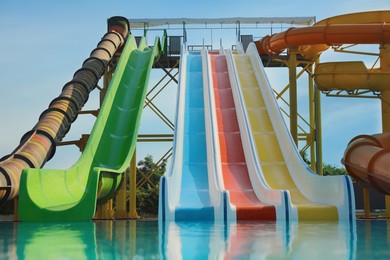 Photo of Beautiful view of water park with colorful slides and swimming pool on sunny day