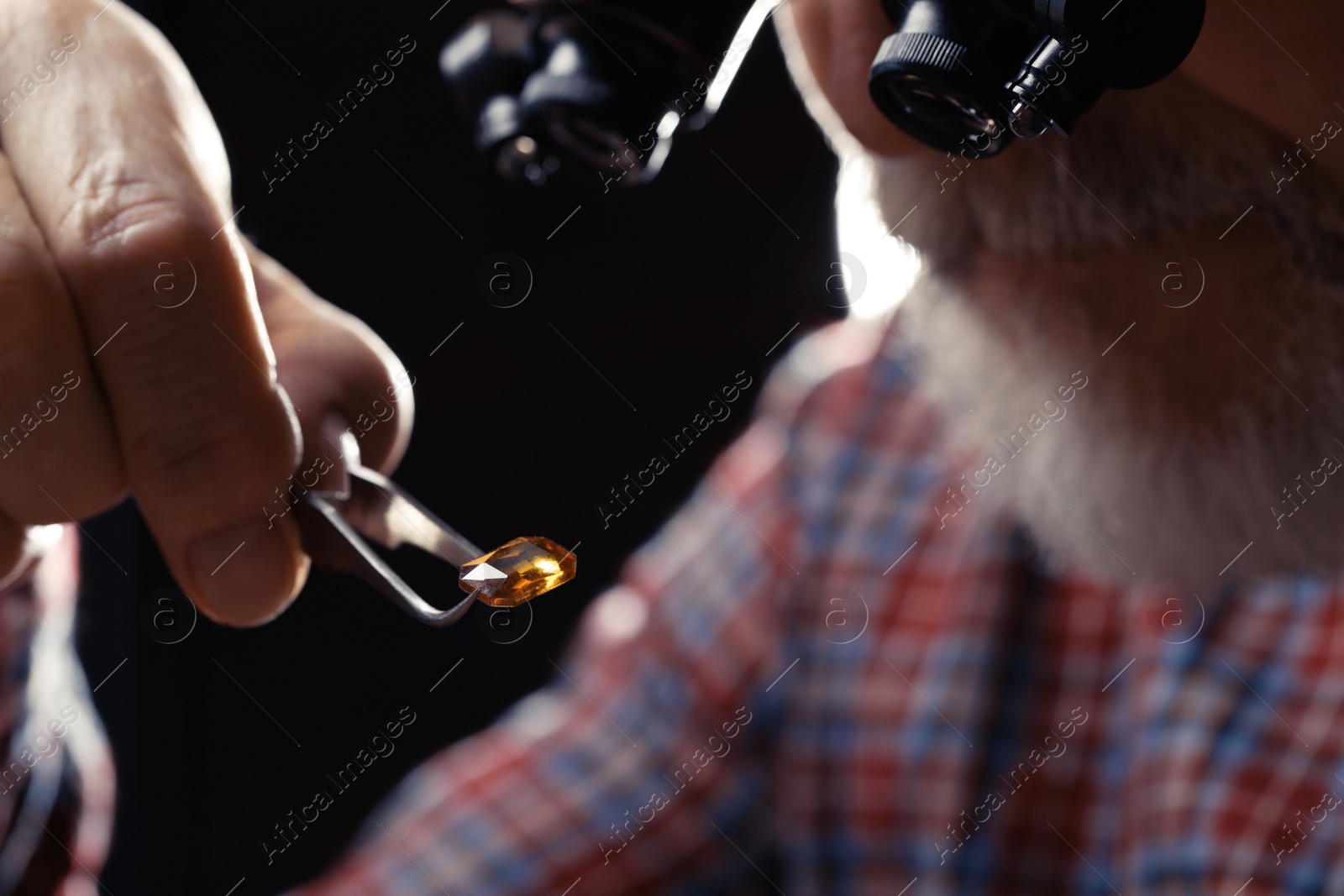 Photo of Professional jeweler working with gemstone, closeup view