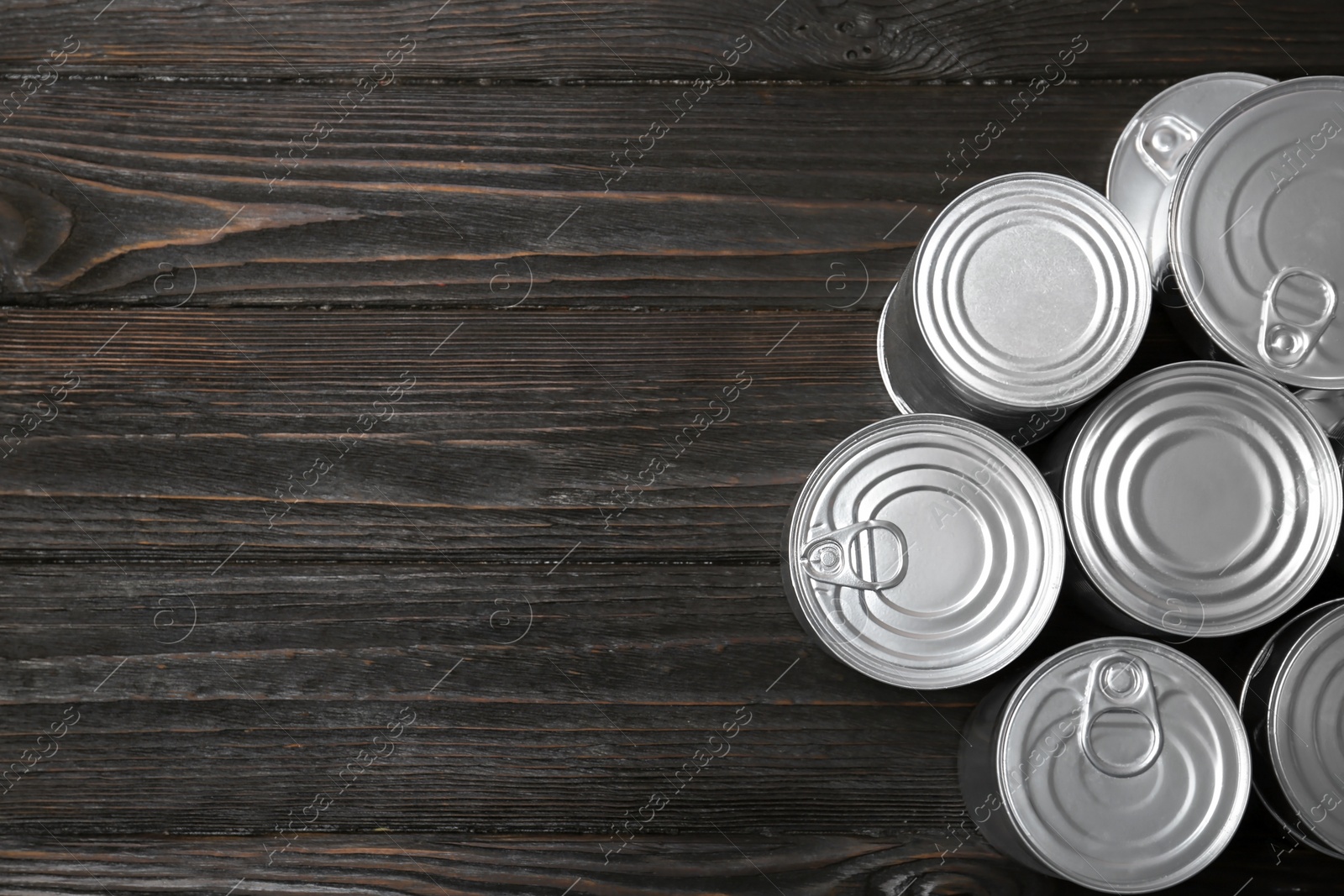 Photo of Many tin cans on wooden background, top view. Recycling garbage