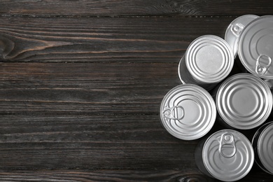 Many tin cans on wooden background, top view. Recycling garbage