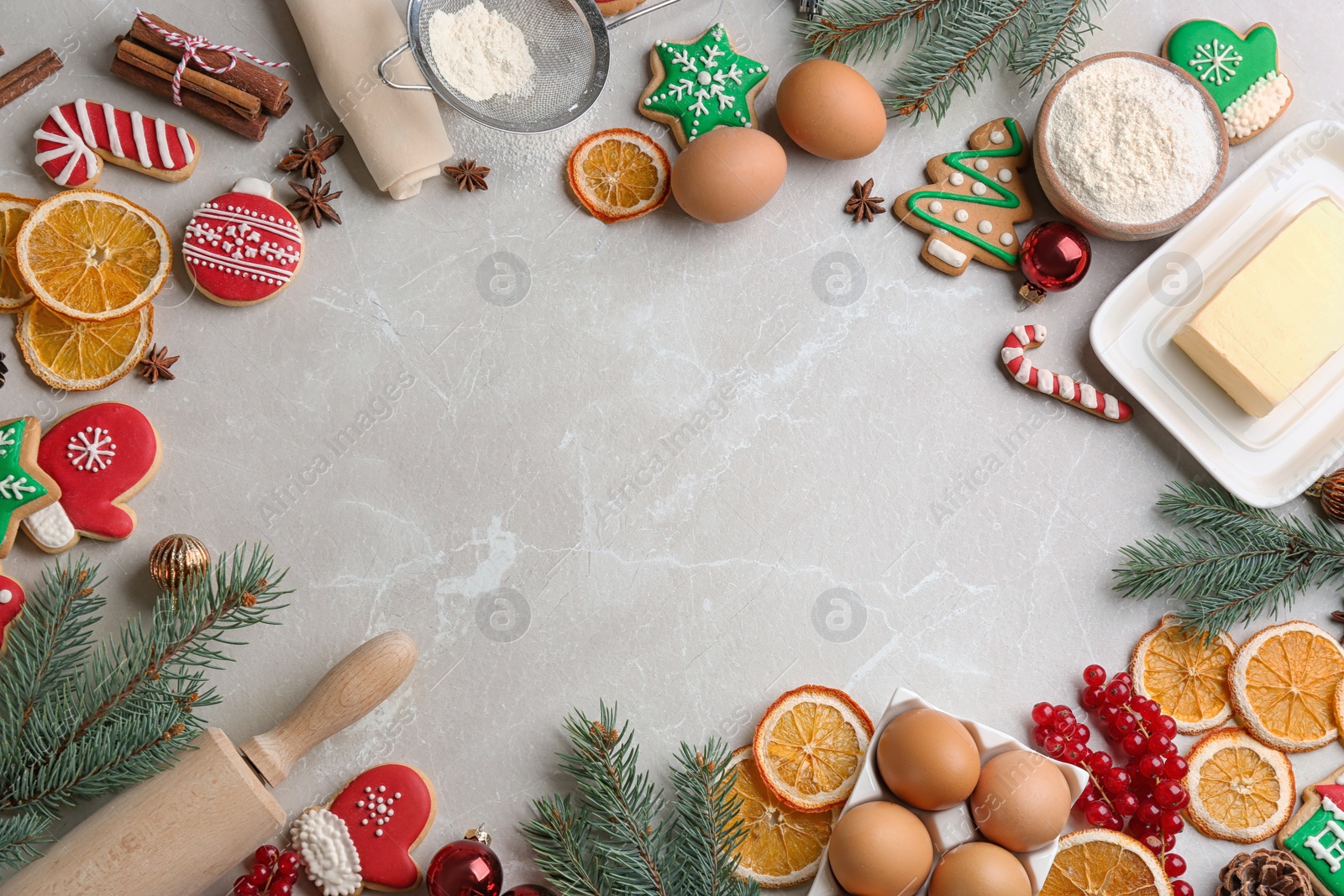 Photo of Flat lay composition with homemade Christmas cookies and ingredients on grey table, space for text