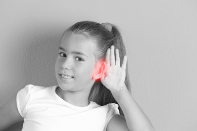 Image of Little girl with hearing problem. Black and white tone