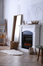 Photo of Beautiful living room interior with fireplace near white wall