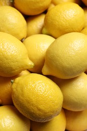 Fresh lemons as background, closeup. Citrus fruit