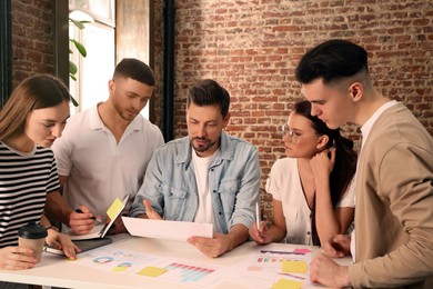 Team of employees working together in office