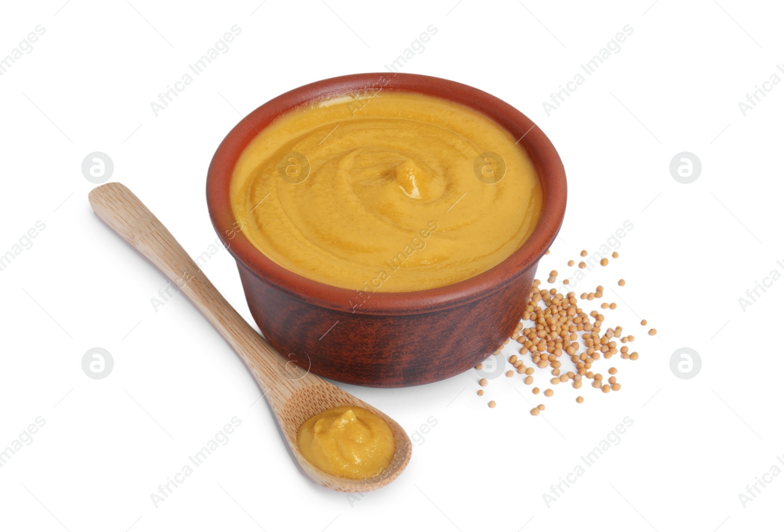 Photo of Fresh tasty mustard sauce in bowl, spoon and dry seeds isolated on white