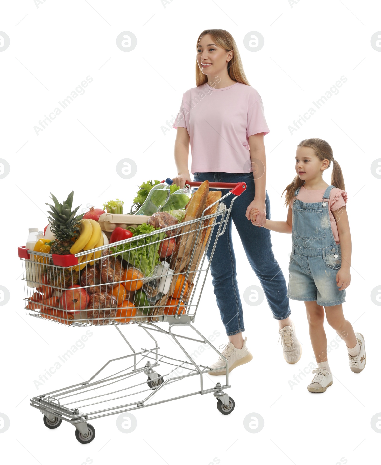 Photo of Mother and daughter with full shopping cart on white background