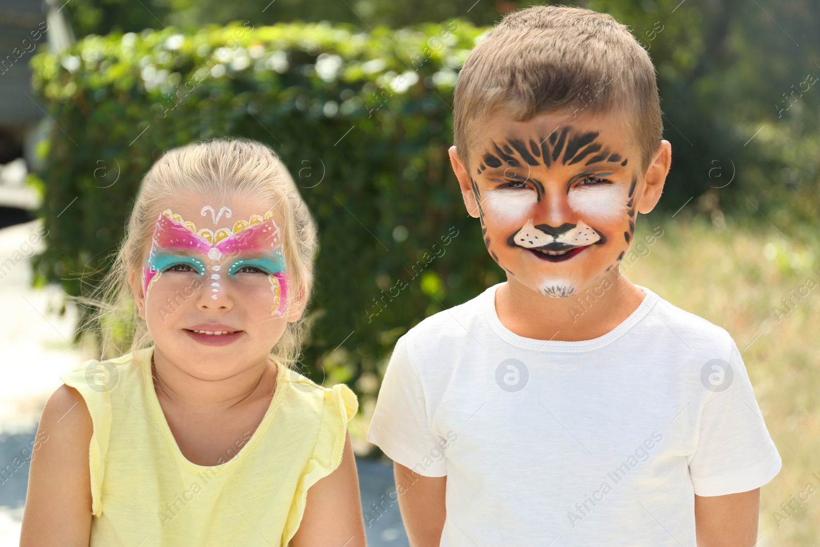 Photo of Cute little children with face painting outdoors