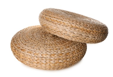 Photo of Two stylish wicker poufs on white background