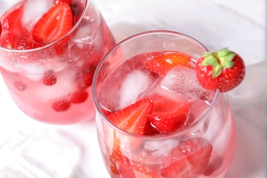 Glasses of natural lemonade with berries on table, closeup