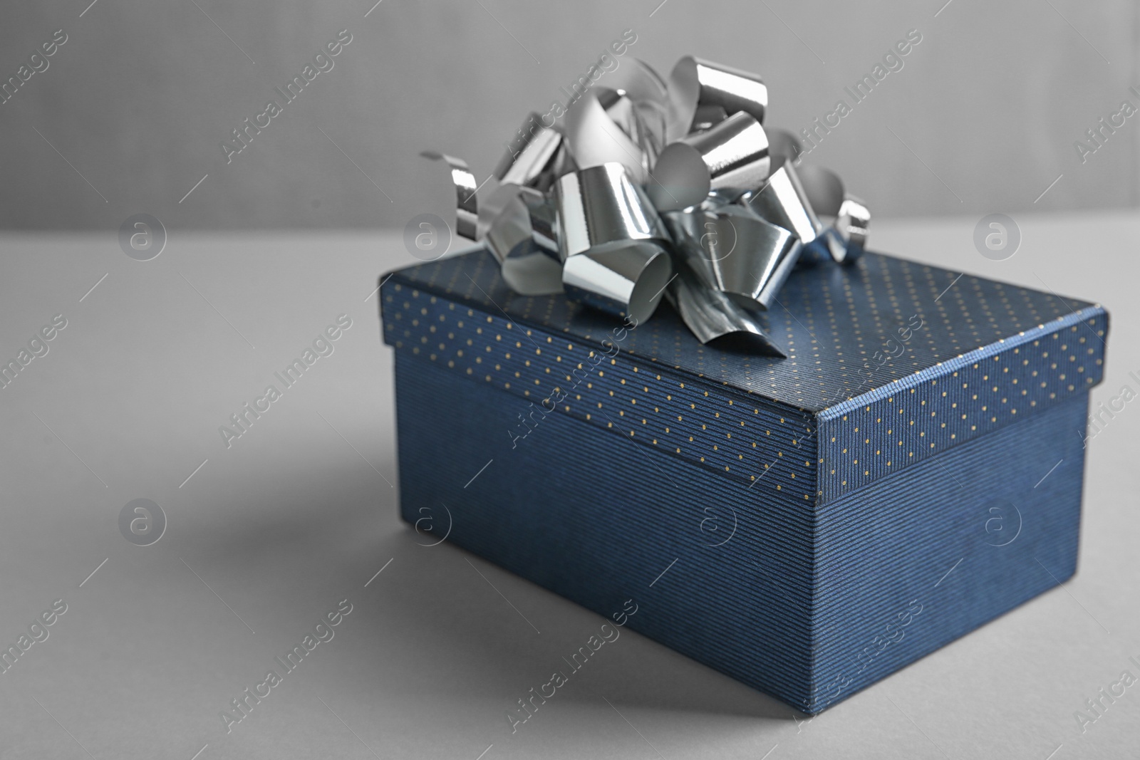 Photo of Beautiful gift box with bow on light table