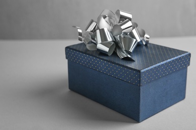 Beautiful gift box with bow on light table