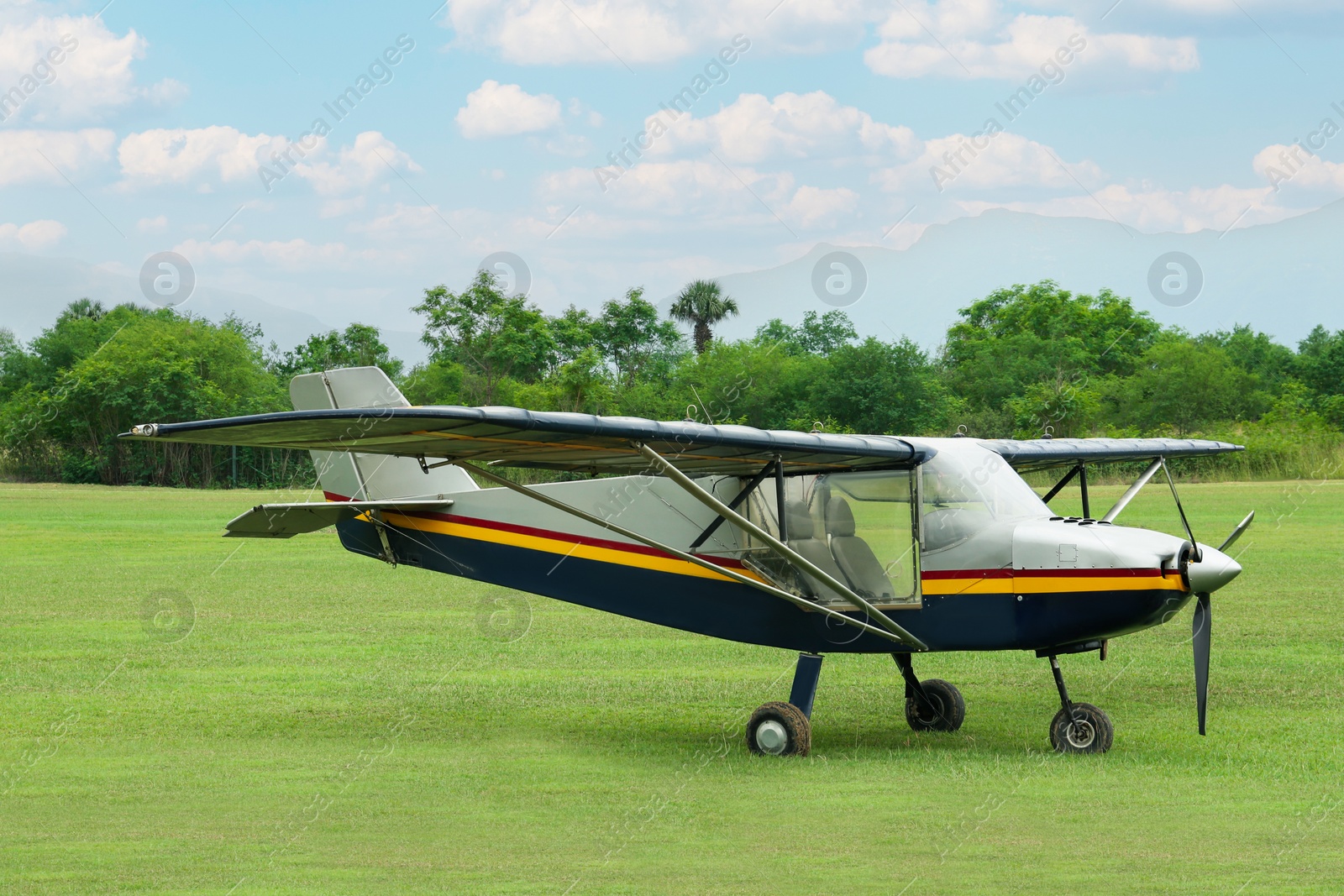 Photo of View of beautiful ultralight airplane in field on autumn day