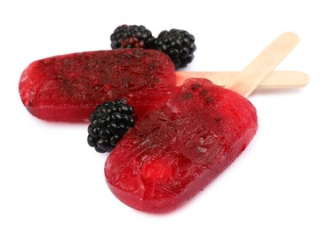 Photo of Delicious ice pops and fresh blackberries on white background. Fruit popsicle