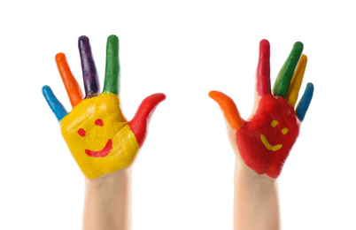 Photo of Kid with smiling faces drawn on palms against white background, closeup