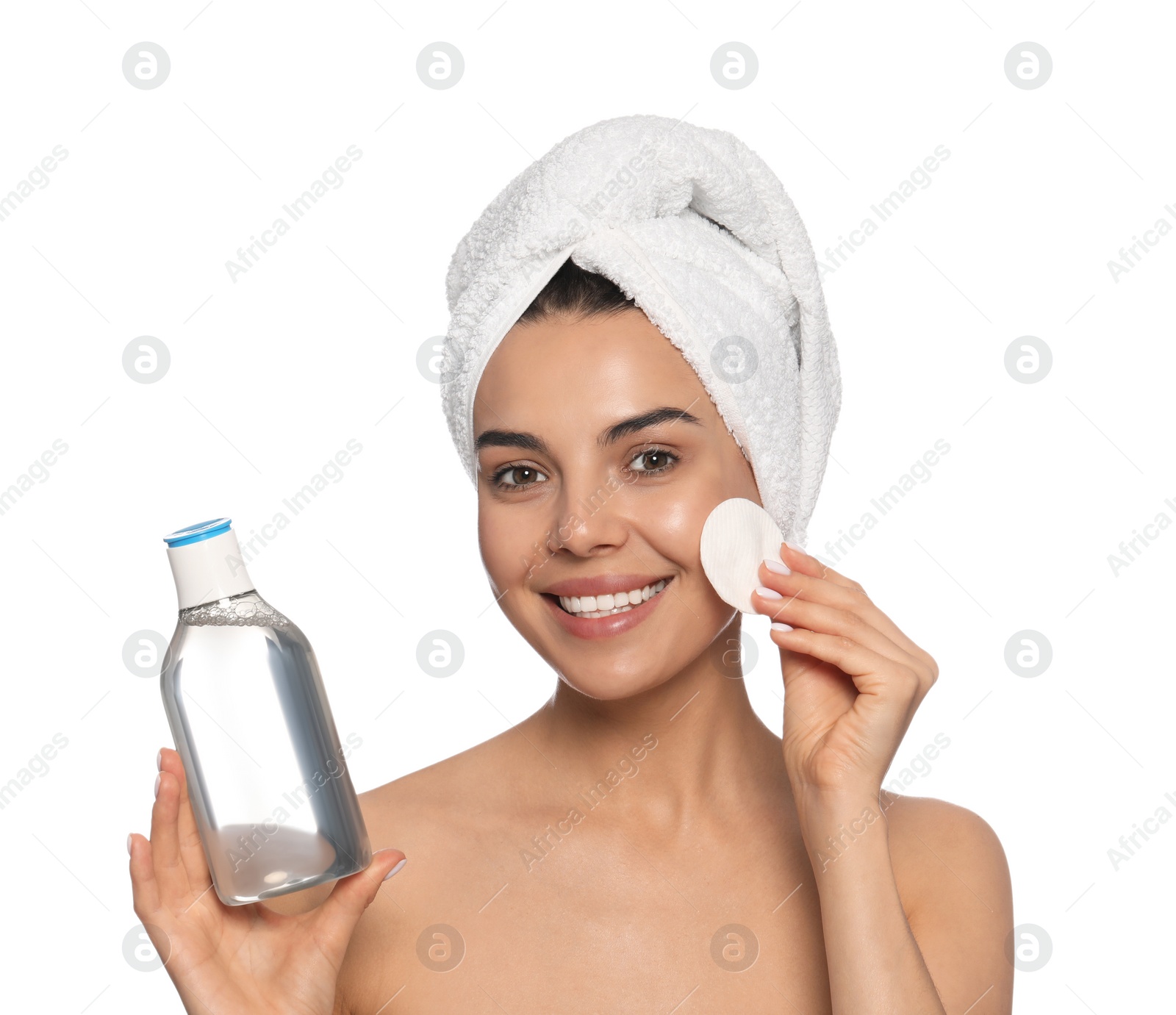 Photo of Young woman using cotton pad with micellar water on white background