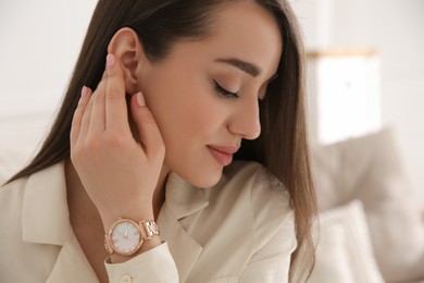 Photo of Woman with luxury wristwatch on blurred background