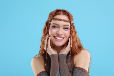 Photo of Beautiful young hippie woman on light blue background