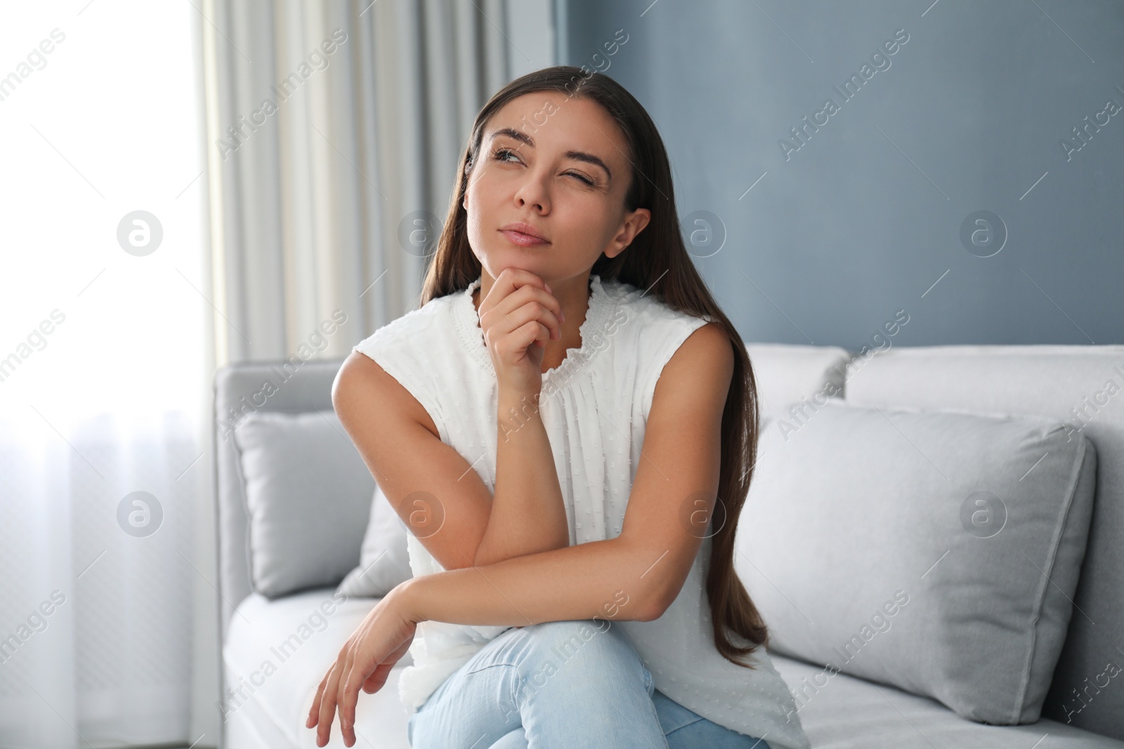 Photo of Young woman talking to his coworkers through video conference indoors, view from webcam