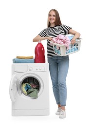 Photo of Beautiful young woman with laundry basket near washing machine on white background