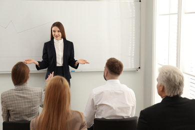 Photo of Professional business trainer working with people in office