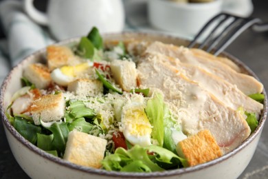 Photo of Delicious Caesar salad in bowl, closeup view