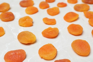 Photo of Tasty apricots on grey background. Dried fruit as healthy food