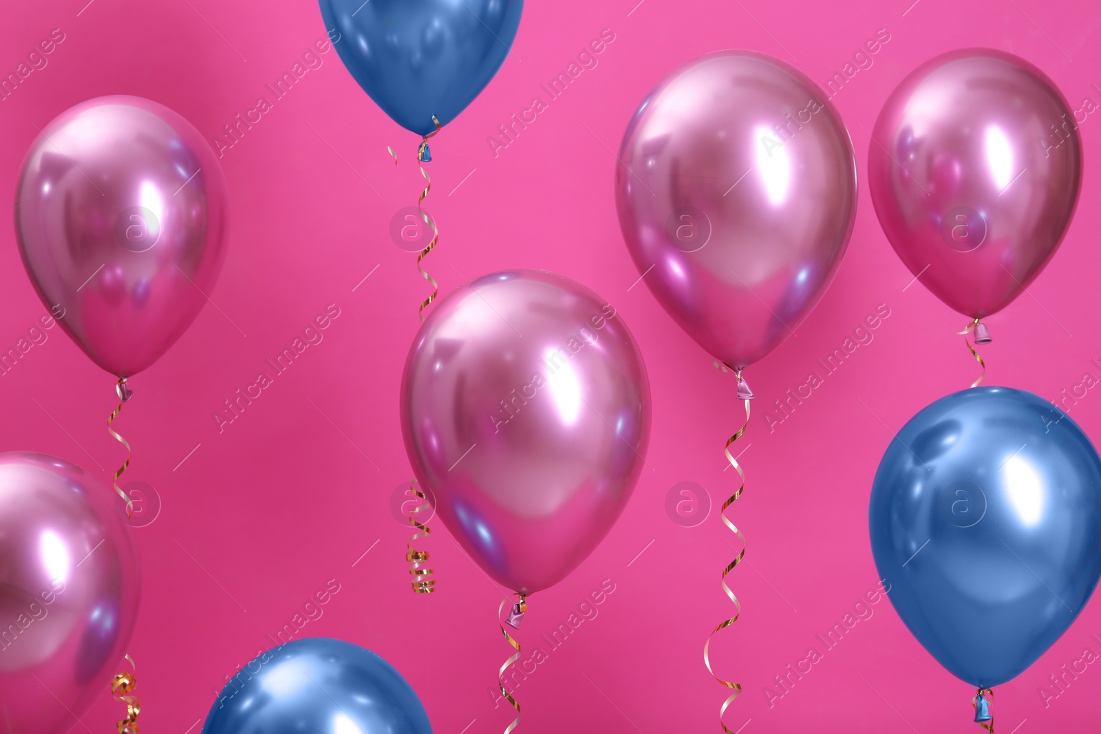 Photo of Bright balloons with ribbons on color background