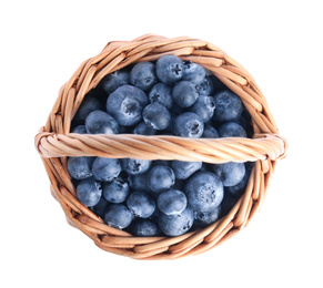 Photo of Fresh tasty blueberries in wicker basket isolated on white, top view