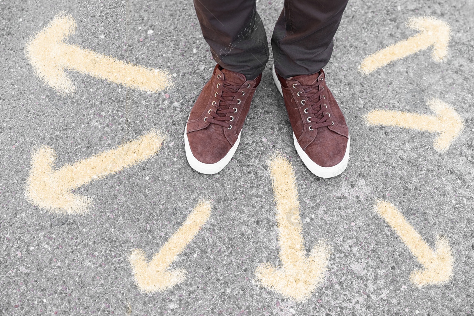 Image of Man standing on road near arrows, closeup