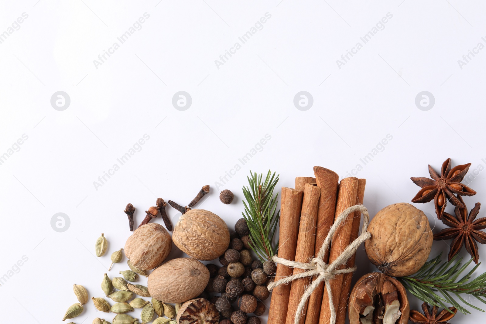 Photo of Different spices and fir branches on white table, flat lay. Space for text