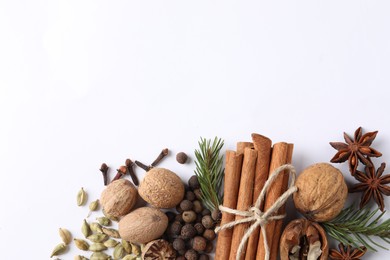 Photo of Different spices and fir branches on white table, flat lay. Space for text