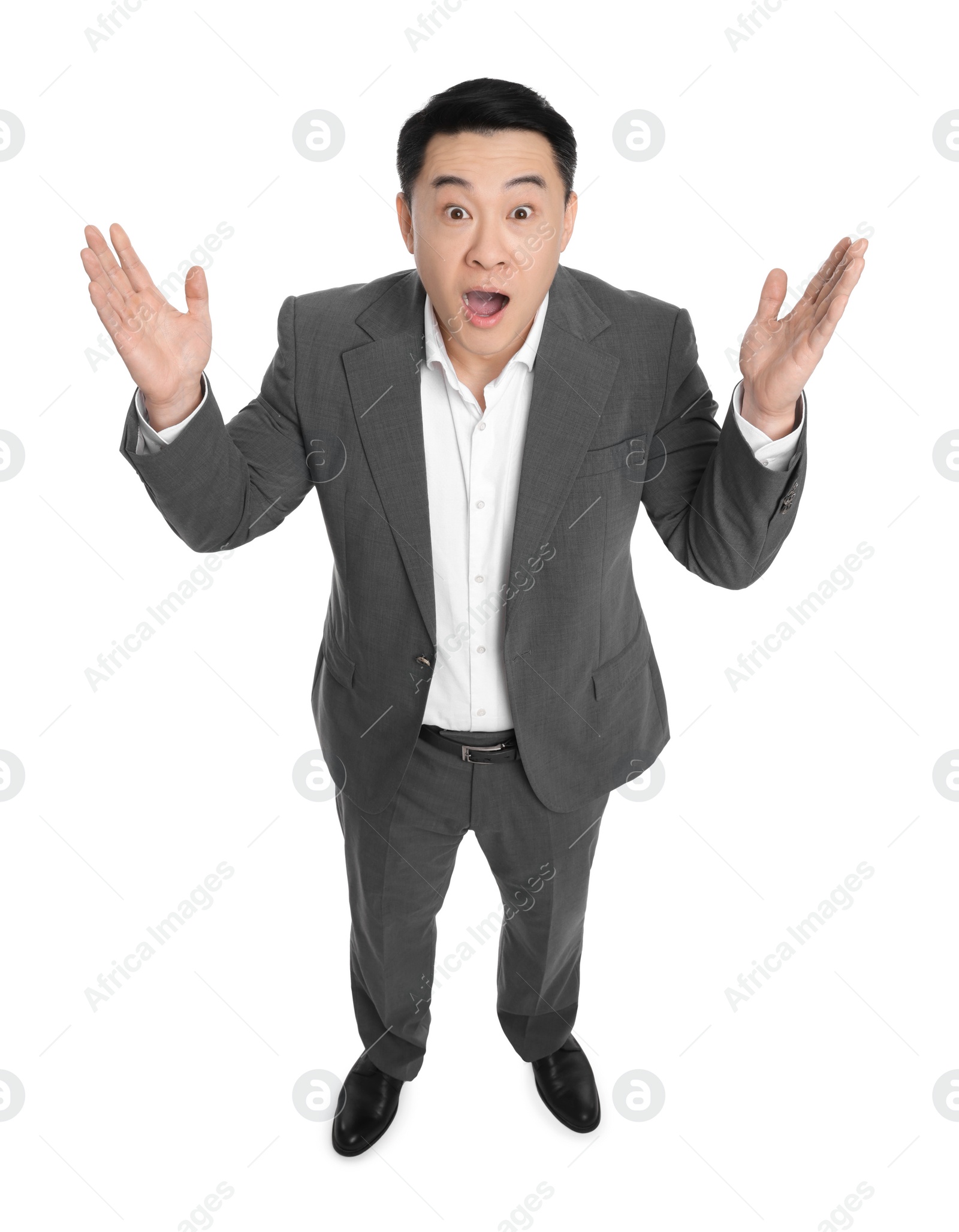 Photo of Shocked businessman in suit posing on white background, above view