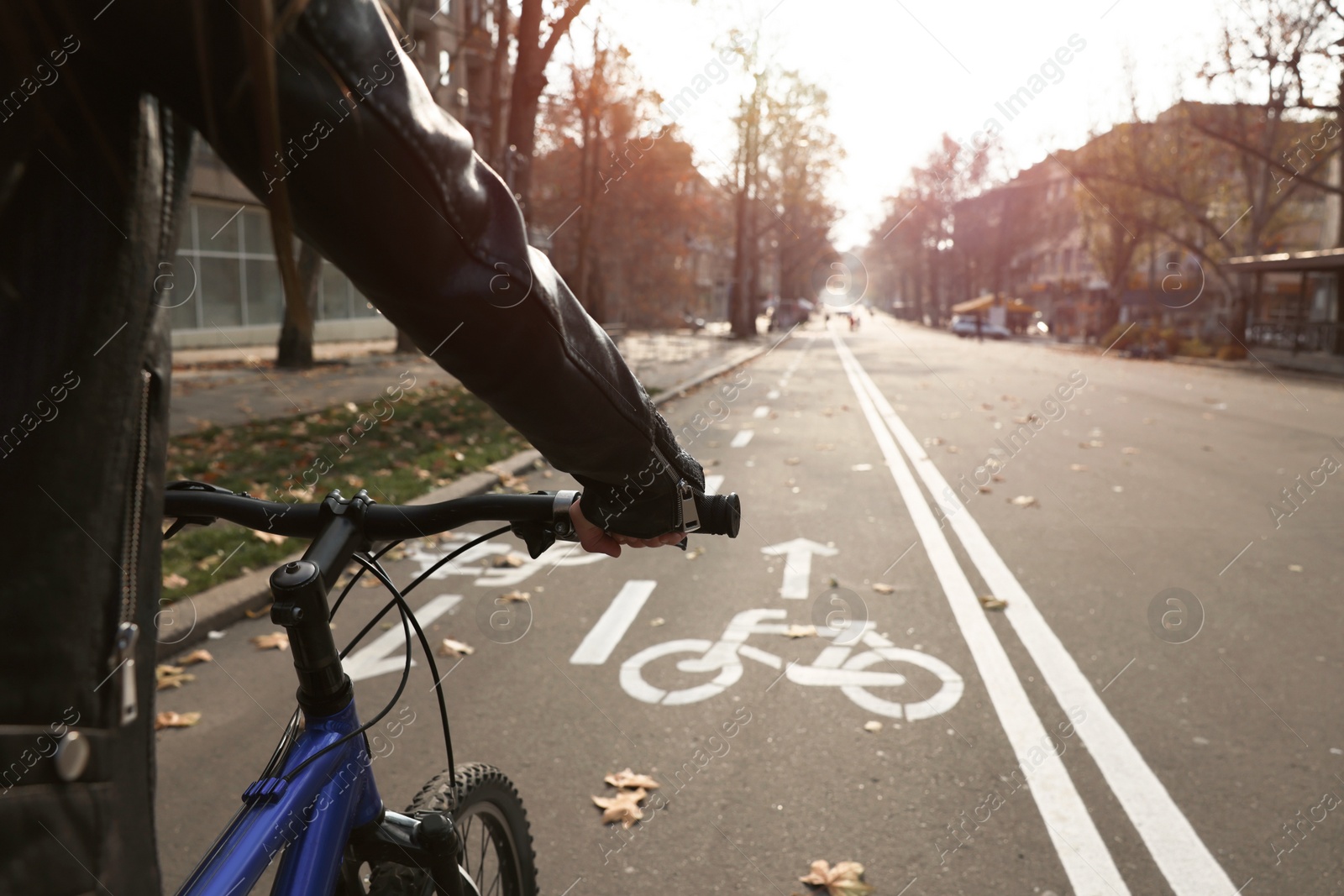 Photo of Woman riding bicycle on lane in city, closeup