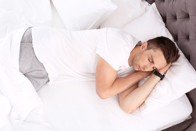 Photo of Young man sleeping in bed at home