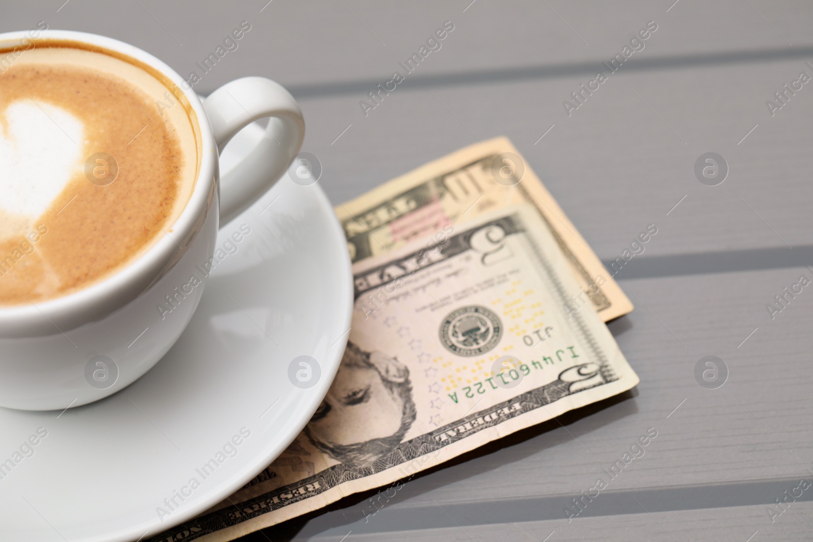 Photo of Tips and cup of coffee on table, closeup