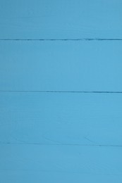 Photo of Texture of light blue wooden surface as background, closeup