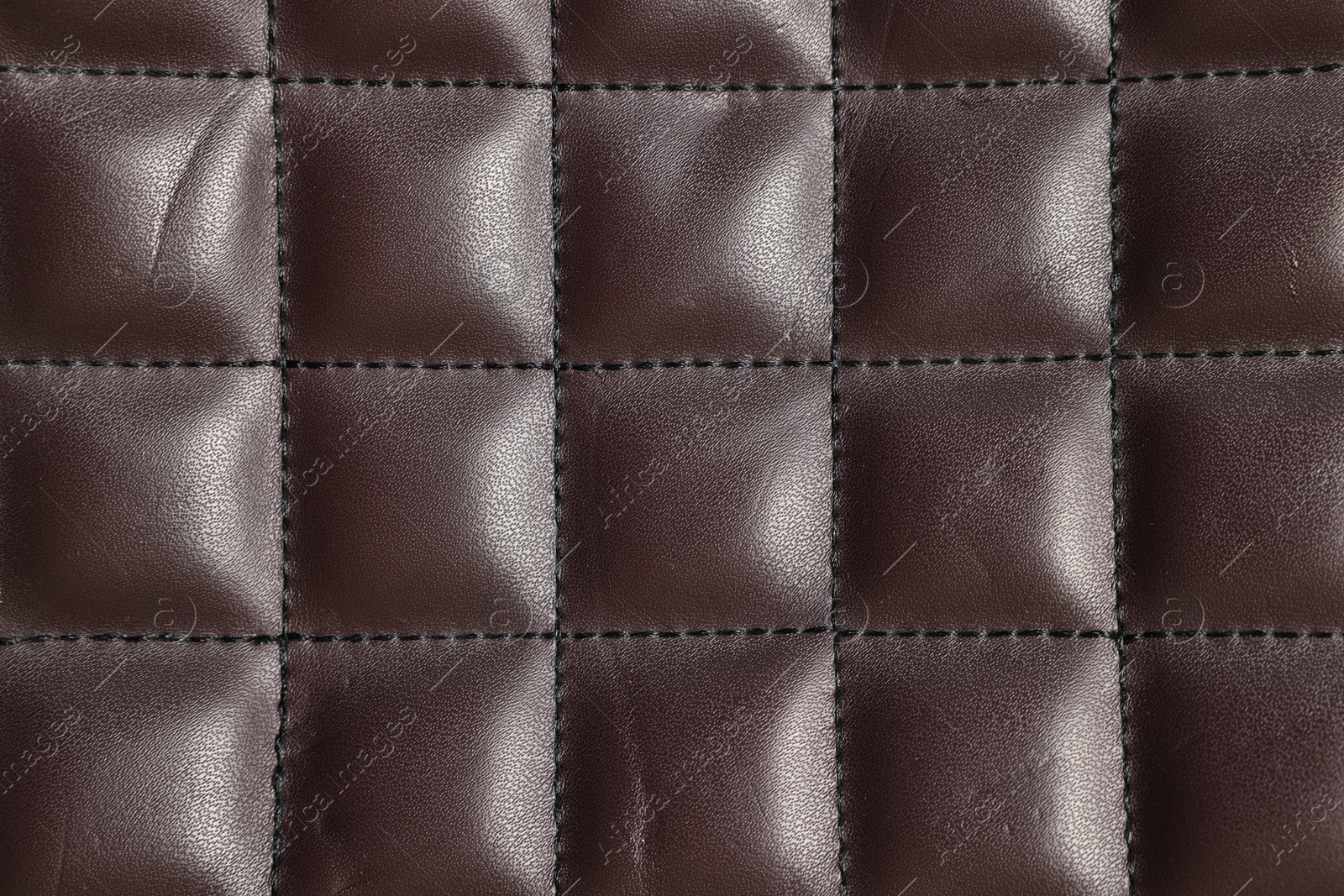 Photo of Brown natural leather with seams as background, top view