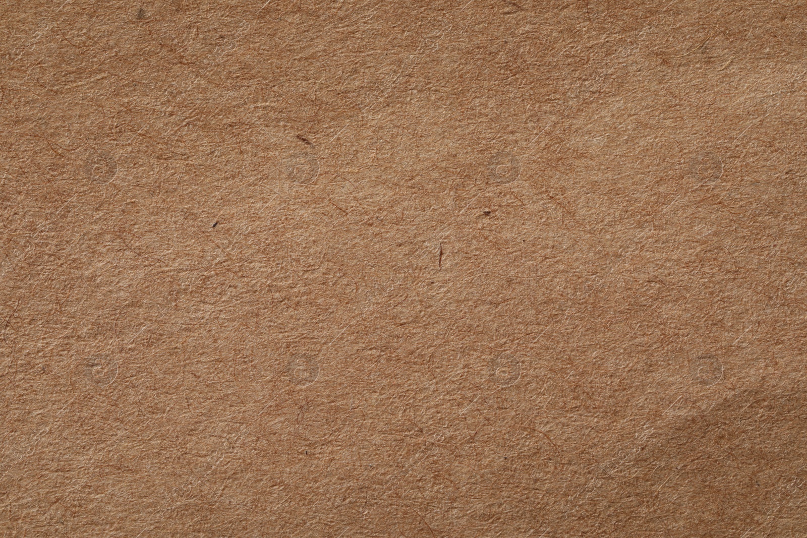 Photo of Texture of kraft paper sheet as background, closeup