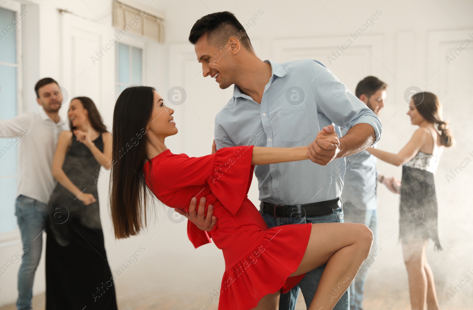 Photo of Lovely young couple dancing together at party