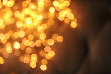 Photo of Gold glitter with bokeh effect on dark background