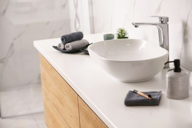 Stylish vessel sink on light countertop in modern bathroom