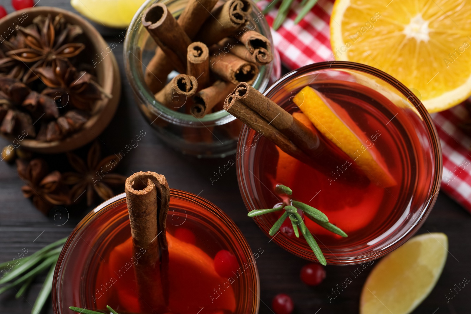 Photo of Aromatic punch drink and ingredients on wooden table, flat lay